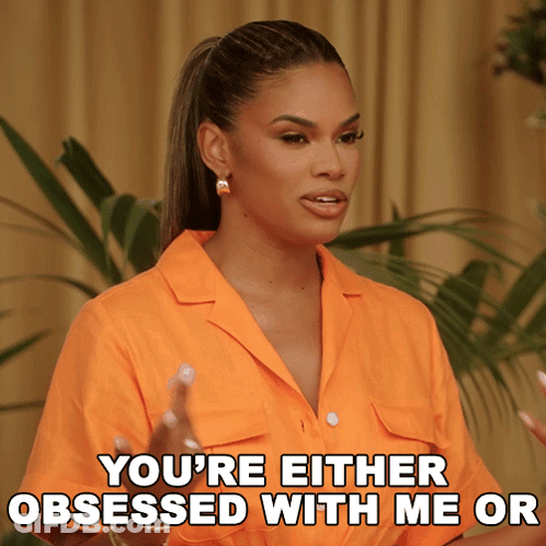 Woman In Orange Shirt Saying You're Obsessed GIF