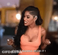 Woman In Orange Tank Top Saying Don't Wanna Hear It GIF
