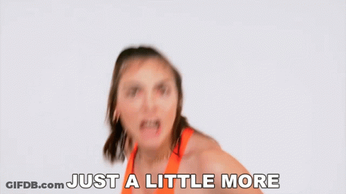 Woman In Orange Top Saying Just A Little More GIF