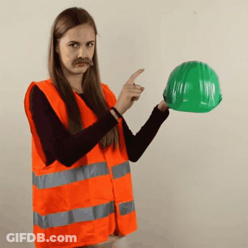 Woman In Orange Vest Pointing At Green Helmet GIF