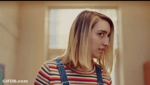 Woman In Overalls And Striped Shirt Looking To Side GIF