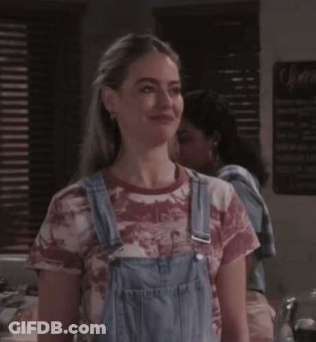 Woman In Overalls And Tie-Dye Shirt With Sprite Sign GIF