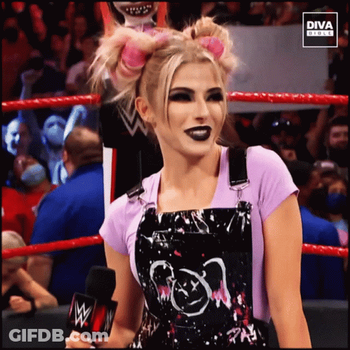 Woman In Overalls In Wrestling Ring With Diva Circle Logo GIF