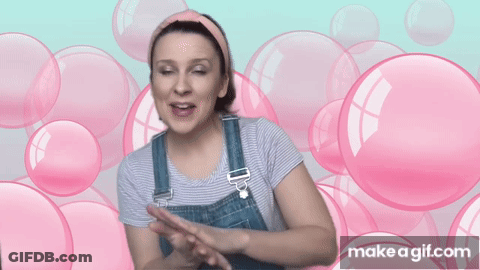 Woman In Overalls Surrounded By Pink Bubbles Says Make A GIF