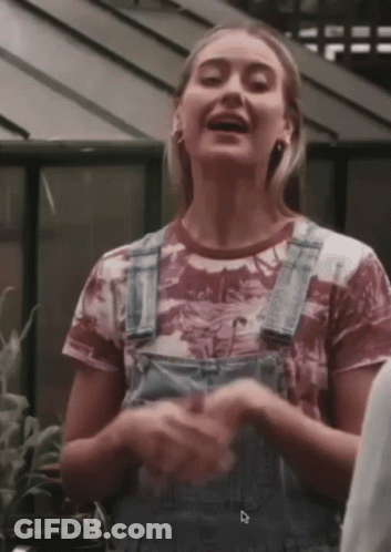 Woman In Overalls With Dinosaur T-Shirt GIF