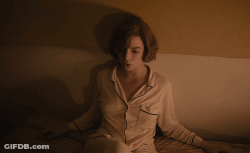 Woman In Pajamas Sitting On Bed GIF