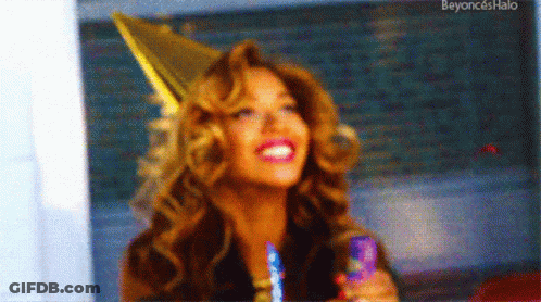 Woman In Party Hat Smiling Holding Candle GIF