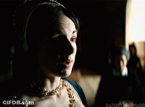 Woman In Pearl Necklace And Crown Standing In Dark GIF