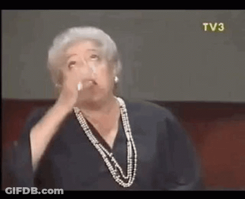 Woman In Pearl Necklace Making Face GIF