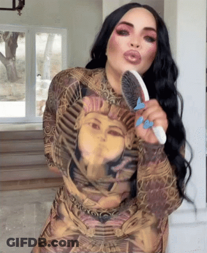 Woman In Pharaoh Dress Brushing Hair GIF