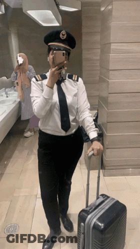 Woman In Pilot Uniform Takes Selfie GIF
