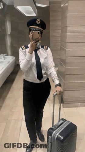 Woman In Pilot Uniform Taking Selfie GIF
