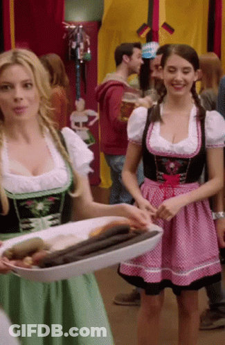 Woman In Pink And Green Dress Holding Tray Of Food GIF