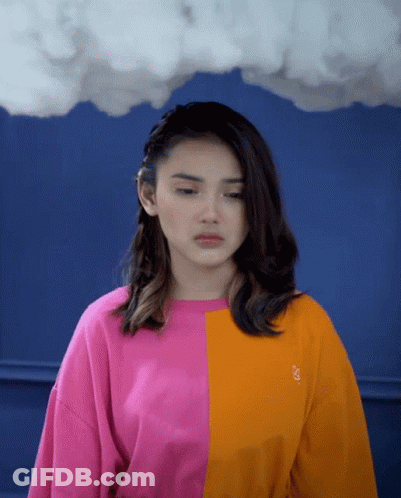 Woman In Pink And Orange Sweater With Letter S GIF