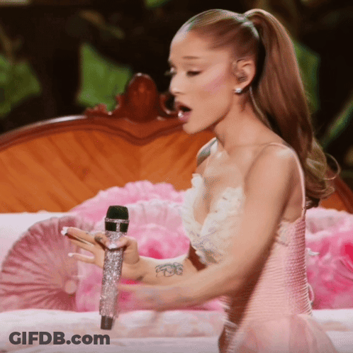 Woman In Pink And White Dress Holding Microphone GIF