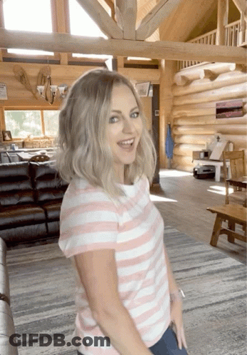 Woman In Pink And White Striped Shirt In Log Cabin GIF