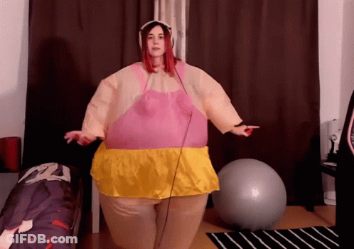 Woman In Pink And Yellow Inflatable Costume With Exercise Ball GIF