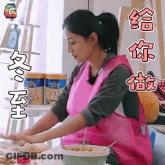 Woman In Pink Apron Preparing Food In Kitchen GIF