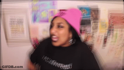 Woman In Pink Beanie And Black T-Shirt GIF