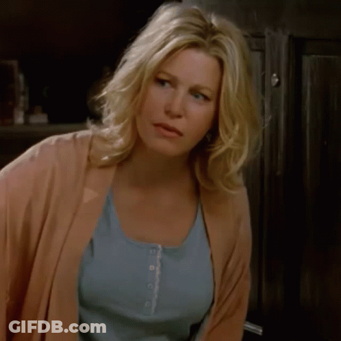 Woman In Pink Cardigan And Blue Tank Top GIF