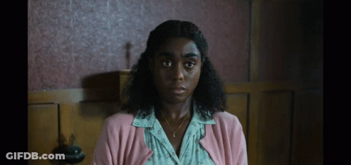 Woman In Pink Cardigan And Gold Necklace GIF