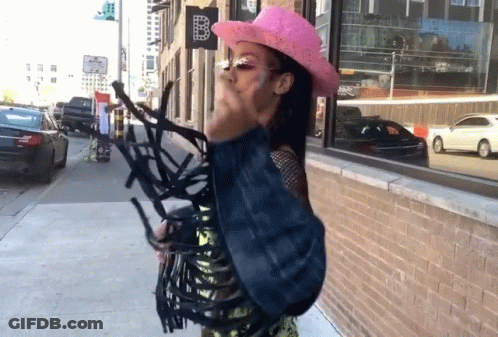 Woman In Pink Cowboy Hat With Sign B GIF