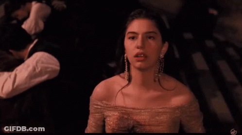 Woman In Pink Dress And Earrings At Camera GIF
