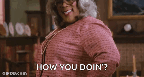 Woman In Pink Dress And Glasses Asking How You Doin GIF