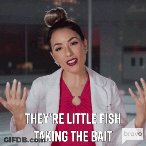 Woman In Pink Dress And White Coat Says They're Little Fish Taking The Bait GIF