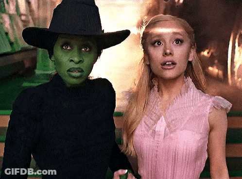 Woman In Pink Dress Beside Woman In Black Hat GIF