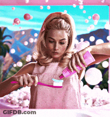Woman In Pink Dress Brushing Teeth GIF