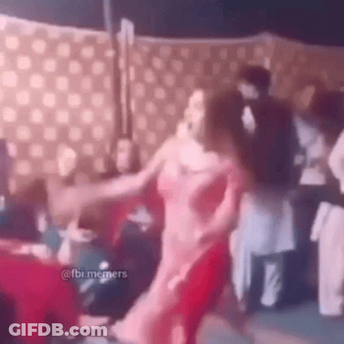 Woman In Pink Dress Dancing In Front Of Crowd GIF