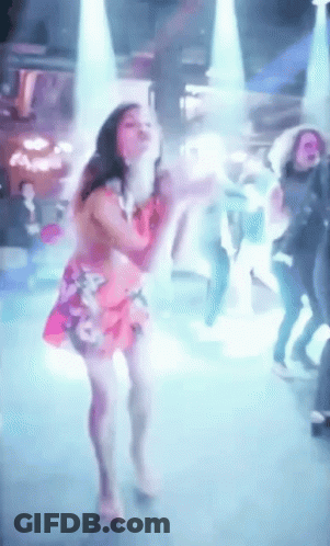 Woman In Pink Dress Dancing In Front Of Crowd GIF