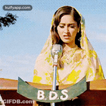Woman In Pink Dress Dancing In Front Of Waterfall GIF