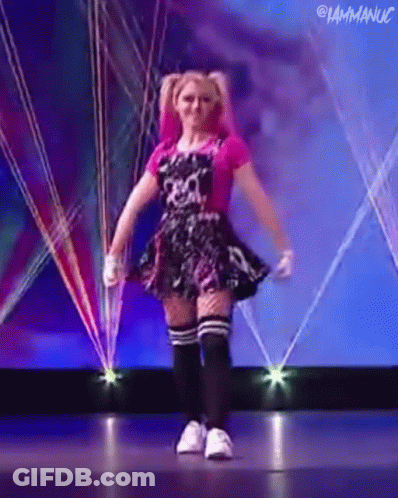 Woman In Pink Dress Dancing On Stage GIF