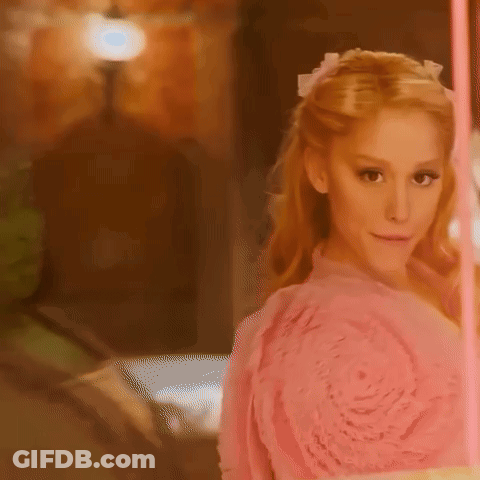 Woman In Pink Dress Facing Mirror GIF
