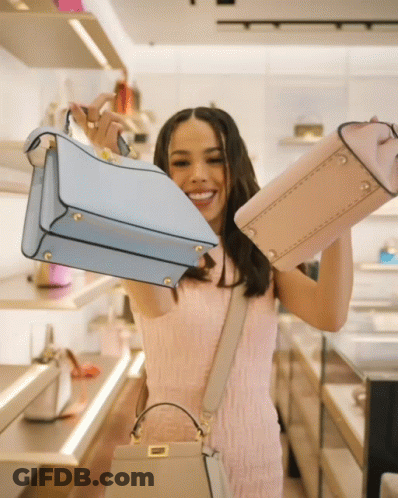 Woman In Pink Dress Holding Blue And Pink Purses GIF
