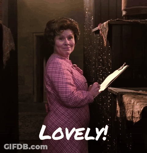 Woman In Pink Dress Holding Clipboard Saying Lovely GIF