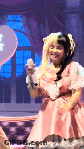 Woman In Pink Dress Holding Microphone GIF