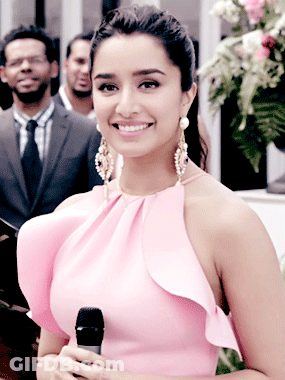 Woman In Pink Dress Holding Microphone Smiling GIF