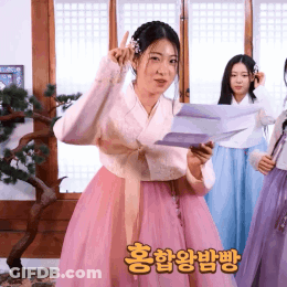 Woman In Pink Dress Holding Paper GIF