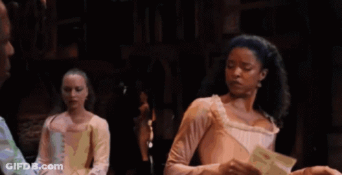 Woman In Pink Dress Holding Paper On Stage GIF