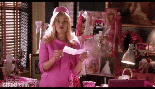 Woman In Pink Dress Holding Paper GIF