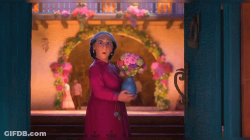 Woman In Pink Dress Holding Vase Of Flowers GIF