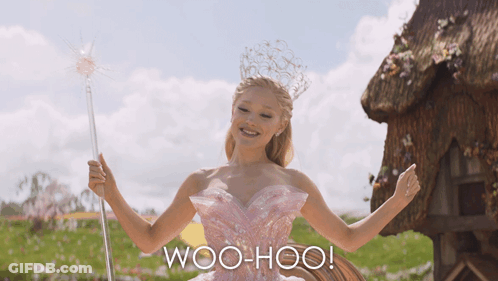 Woman In Pink Dress Holding Wand Saying Woo-Hoo GIF