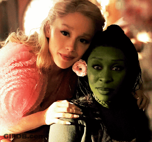 Woman In Pink Dress Hugging Woman In Green Dress GIF