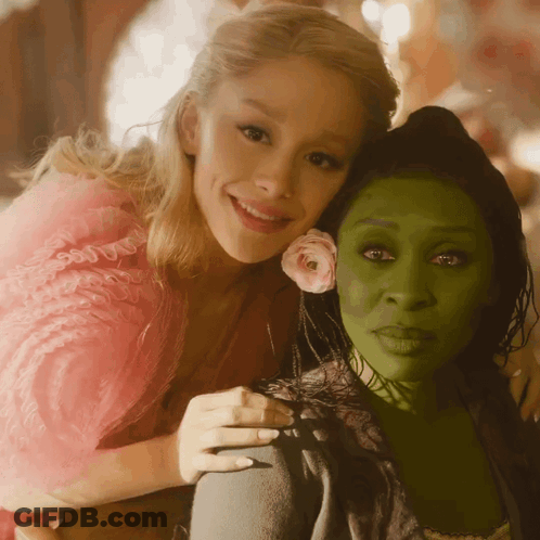 Woman In Pink Dress Hugging Woman In Green Dress GIF