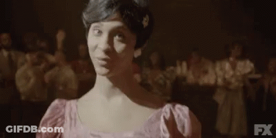 Woman In Pink Dress In Front Of Crowd GIF