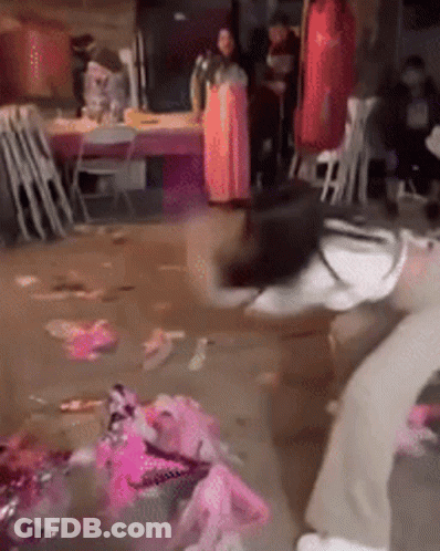 Woman In Pink Dress In Messy Room GIF