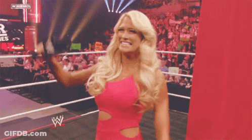 Woman In Pink Dress In Wrestling Ring With WWE Logo GIF